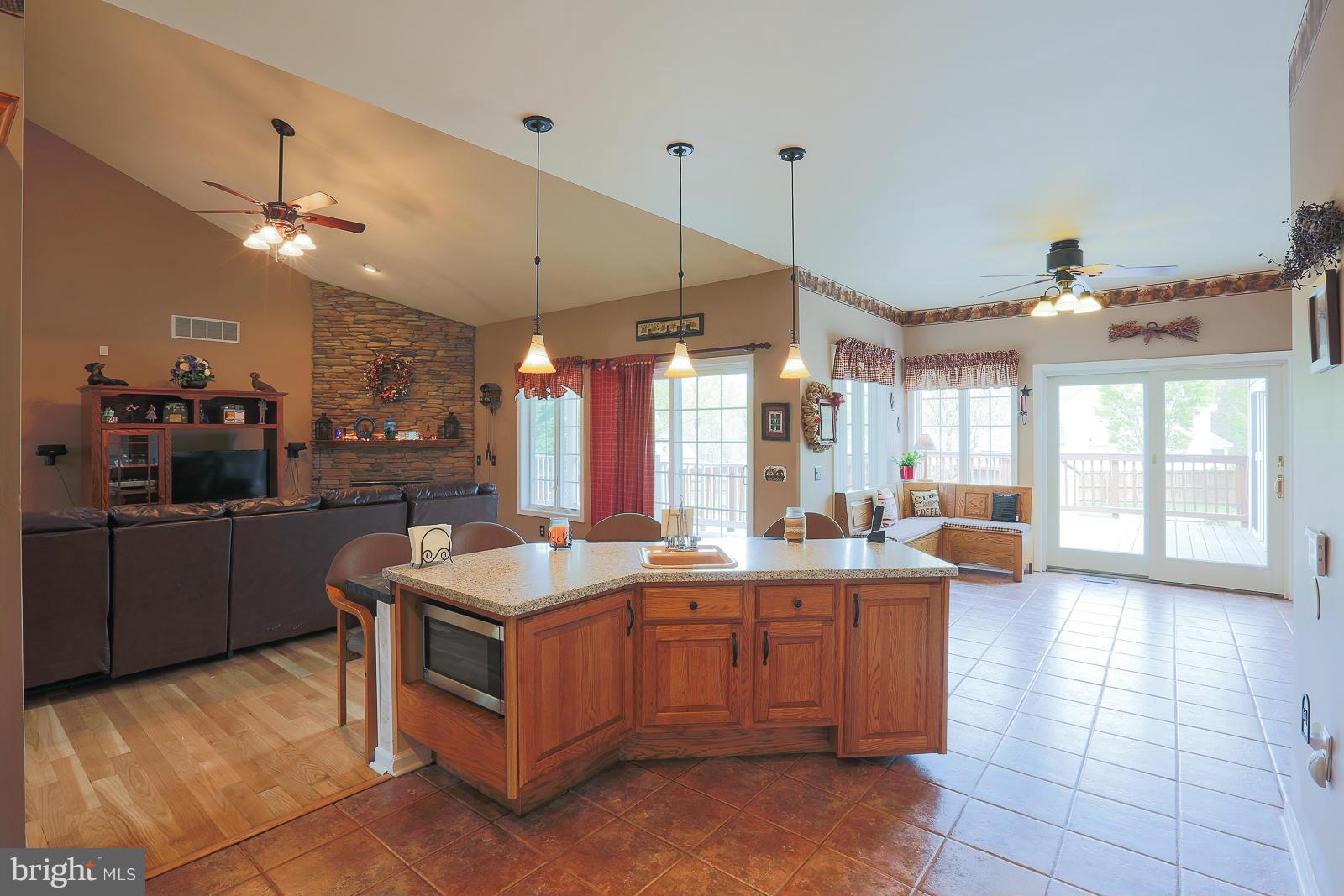 5020 Forge Road Perry Hall, MD 21128 - Photo 10 of 30 a large kitchen with kitchen island a counter a sink a counter space and stainless steel appliances