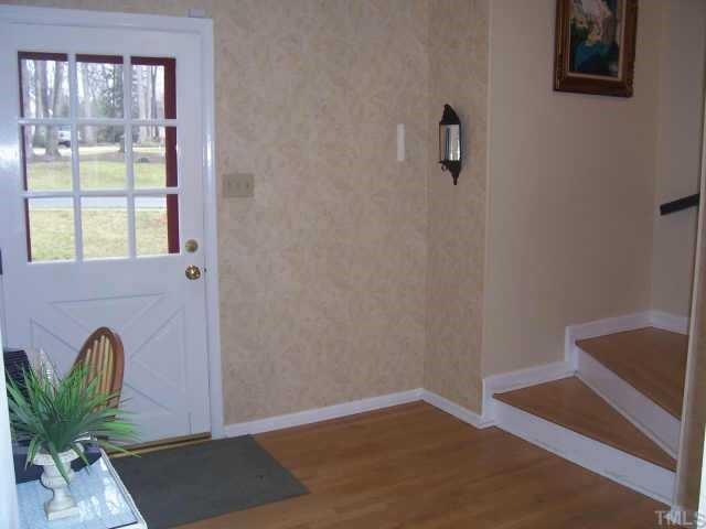 7608 Audubon Drive Raleigh, NC 27615 - Photo 11 of 12 Refreshing Foyer has Hardwood Flooring and Turned Staircase to Living Room. Other
