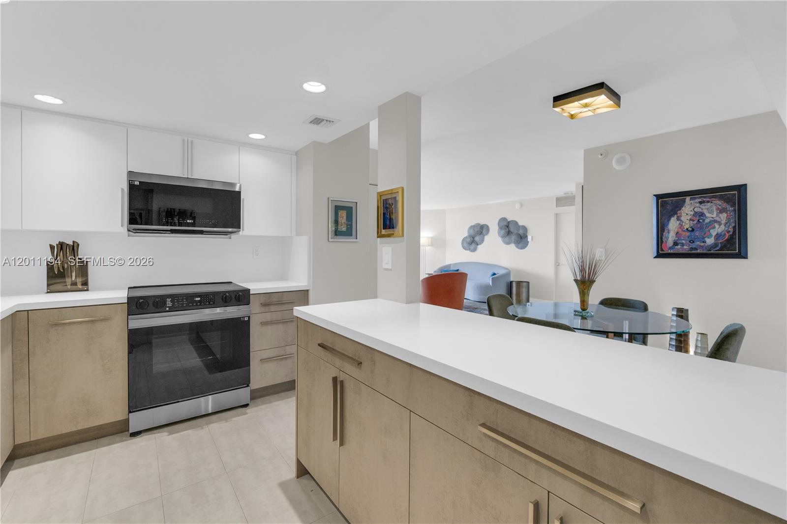 1000 Quayside Terrace, Unit 703 Miami, FL 33138 - Photo 11 of 31 a kitchen with a sink and a stove top oven with wooden floor