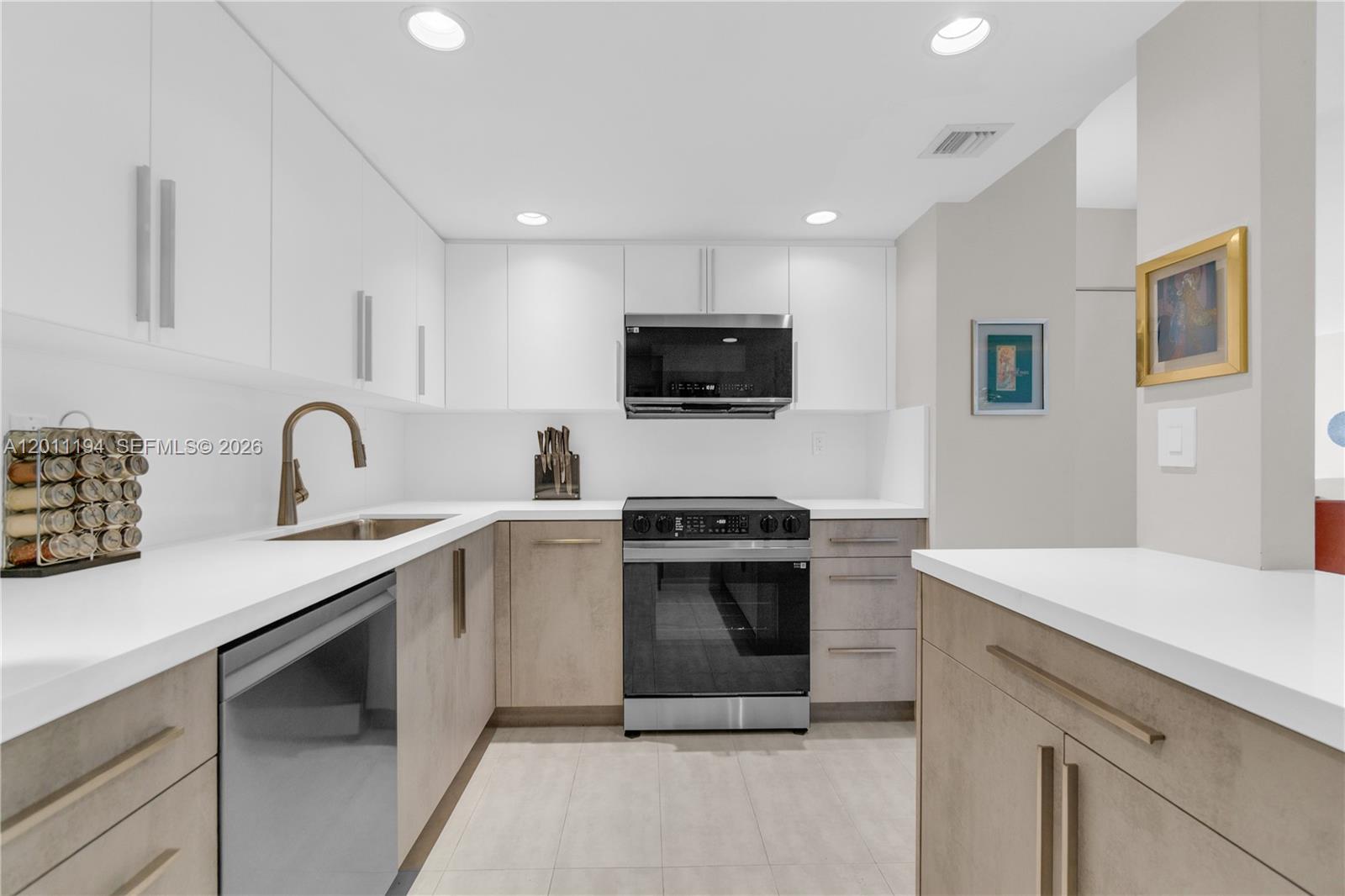 1000 Quayside Terrace, Unit 703 Miami, FL 33138 - Photo 12 of 31 a kitchen with sink a microwave and stove