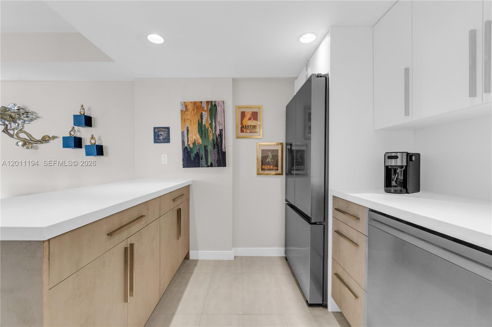 1000 Quayside Terrace, Unit 703 Miami, FL 33138 - Photo 13 of 31 a kitchen with stainless steel appliances a refrigerator a sink and white cabinets