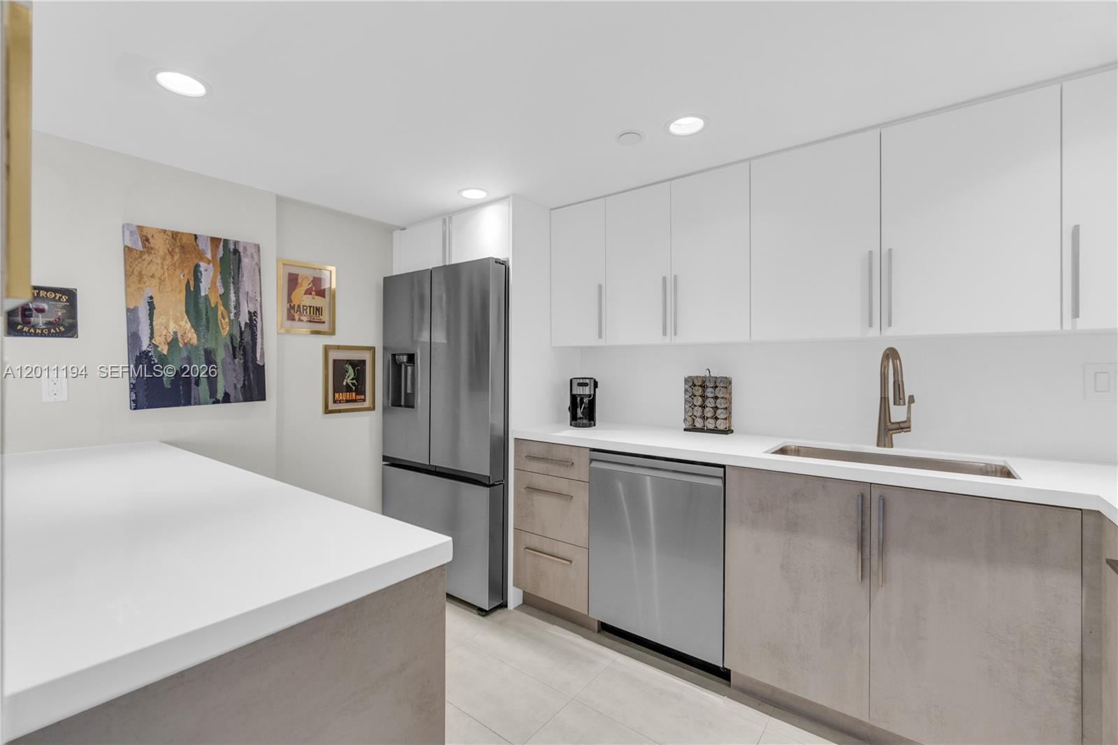 1000 Quayside Terrace, Unit 703 Miami, FL 33138 - Photo 14 of 31 a kitchen with a refrigerator a sink and cabinets