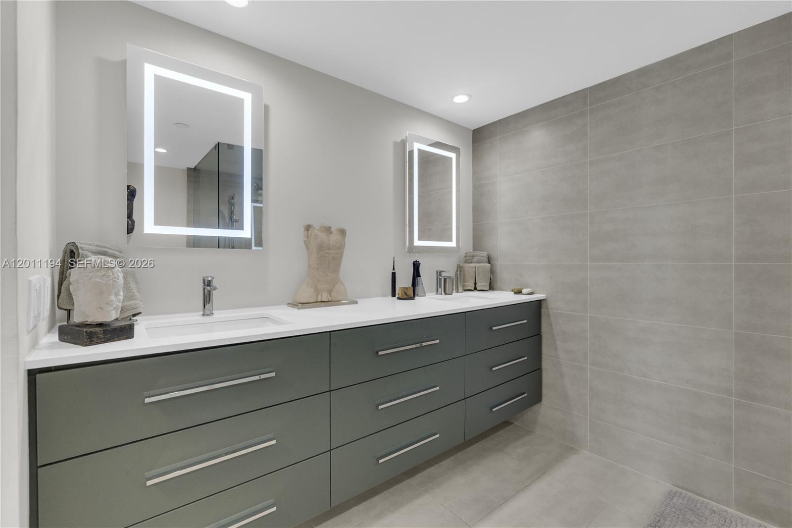 1000 Quayside Terrace, Unit 703 Miami, FL 33138 - Photo 18 of 31 a bathroom with a double vanity sink and mirror