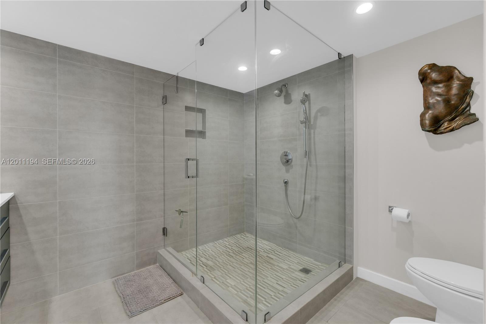 1000 Quayside Terrace, Unit 703 Miami, FL 33138 - Photo 19 of 31 a bathroom with a shower a toilet and a shower