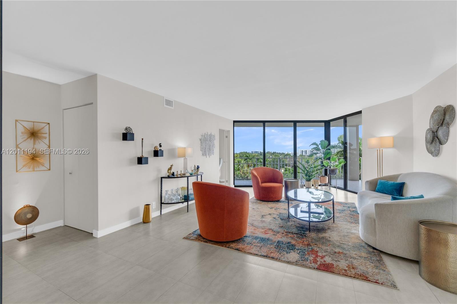1000 Quayside Terrace, Unit 703 Miami, FL 33138 - Photo 2 of 31 a living room with furniture and a potted plant