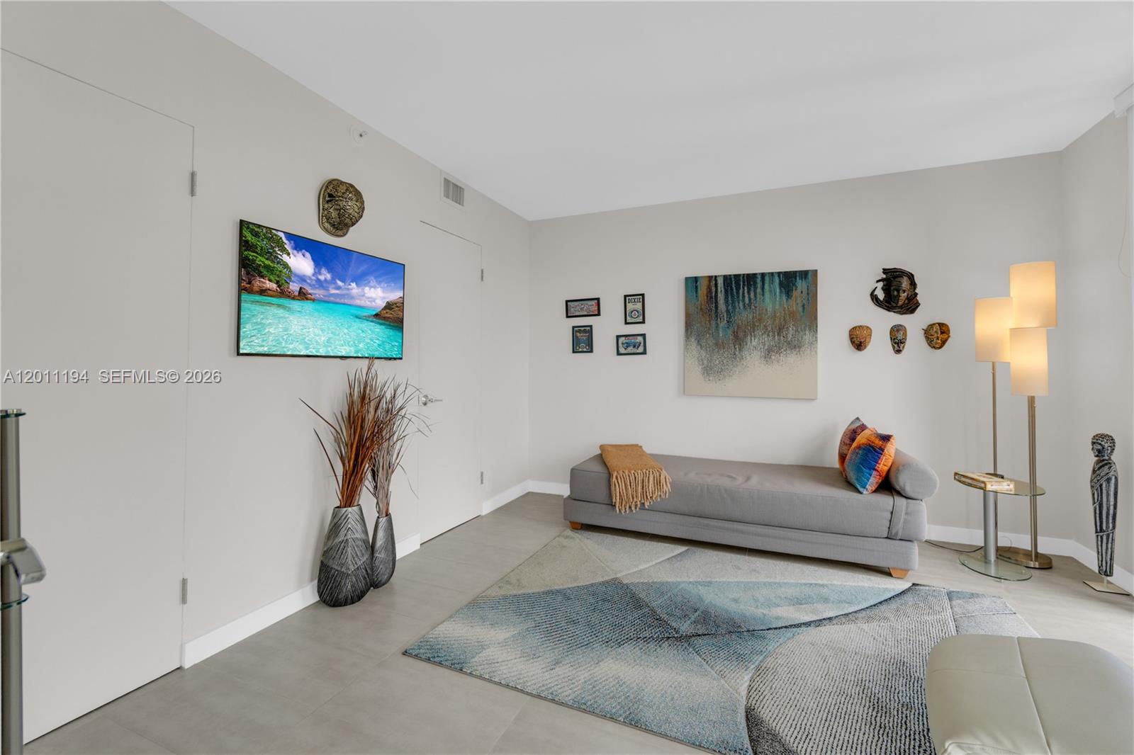 1000 Quayside Terrace, Unit 703 Miami, FL 33138 - Photo 21 of 31 a living room with furniture and a flat screen tv