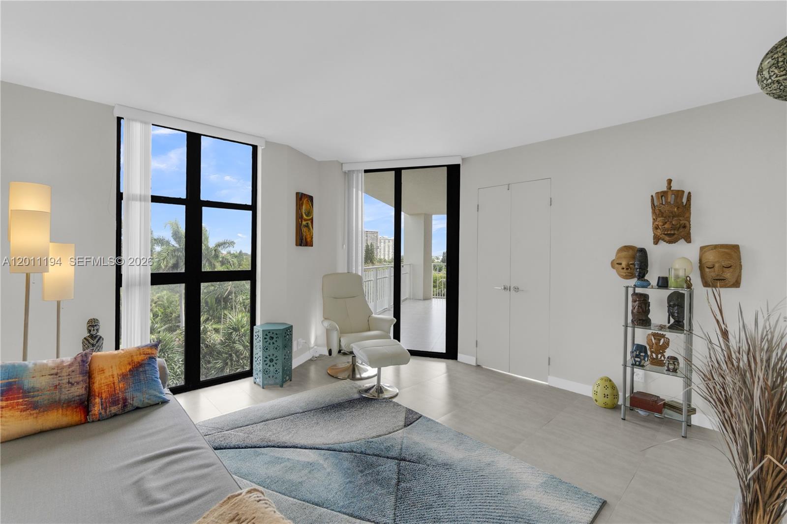 1000 Quayside Terrace, Unit 703 Miami, FL 33138 - Photo 22 of 31 a living room with furniture and a floor to ceiling window