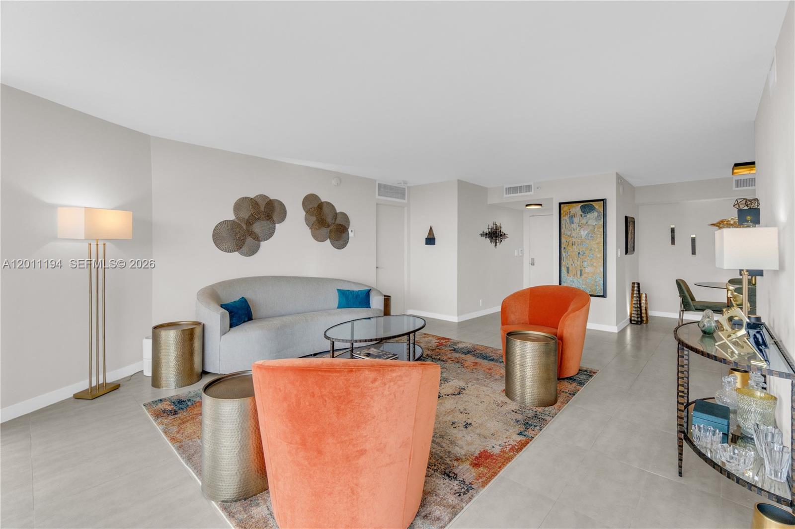 1000 Quayside Terrace, Unit 703 Miami, FL 33138 - Photo 3 of 31 a living room with furniture a rug and a lamp