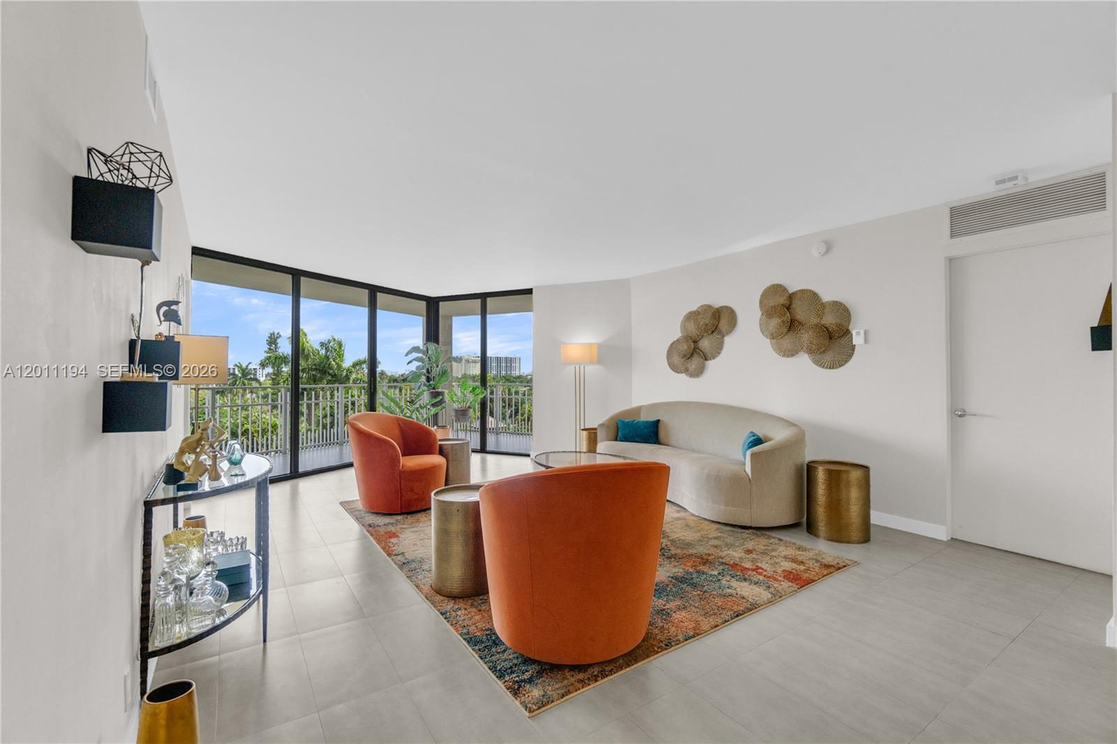 1000 Quayside Terrace, Unit 703 Miami, FL 33138 - Photo 4 of 31 a living room with furniture and a floor to ceiling window