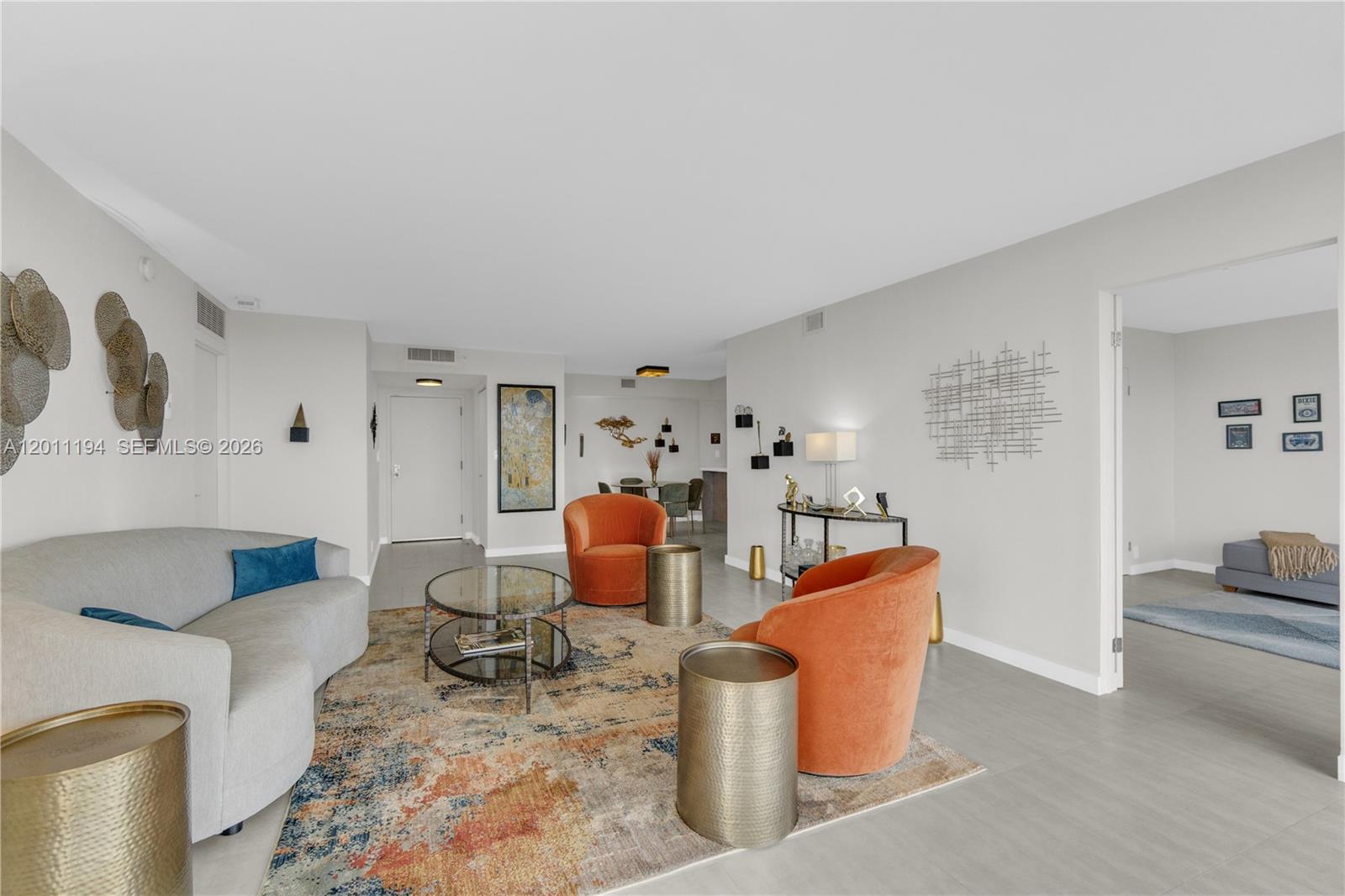 1000 Quayside Terrace, Unit 703 Miami, FL 33138 - Photo 5 of 31 a living room with furniture a rug and a lamp