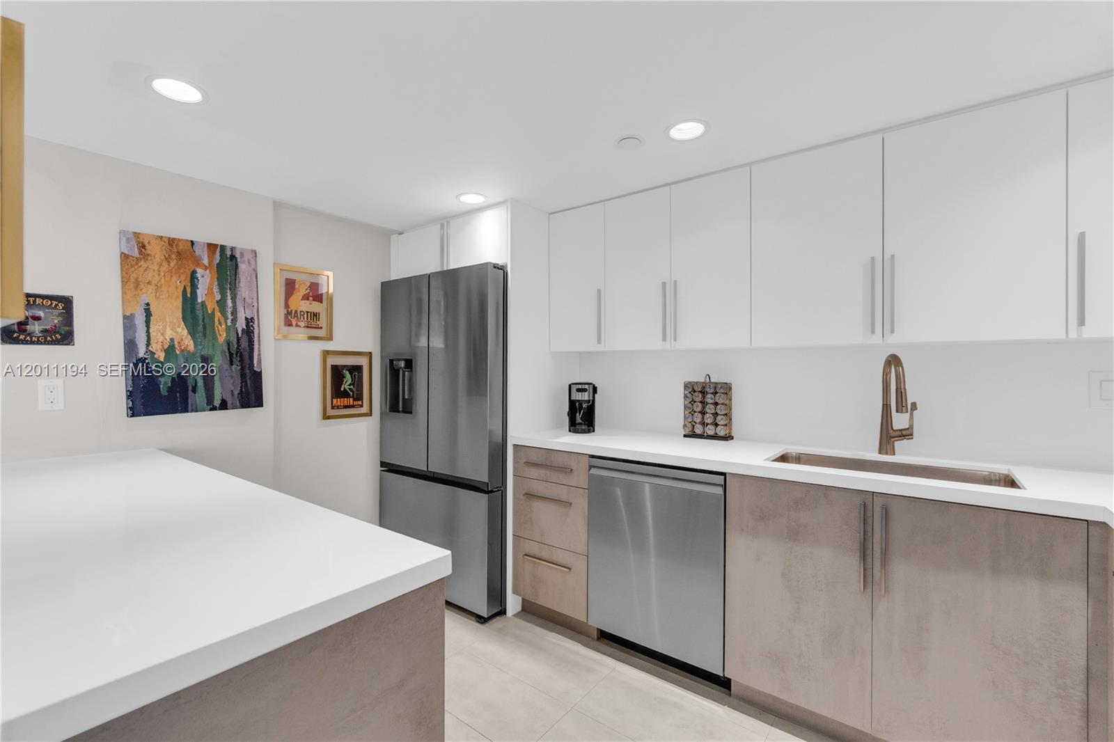 1000 Quayside Terrace, Unit 703 Miami, FL 33138 - Photo 10 of 31 a kitchen with stainless steel appliances a refrigerator sink and white cabinets