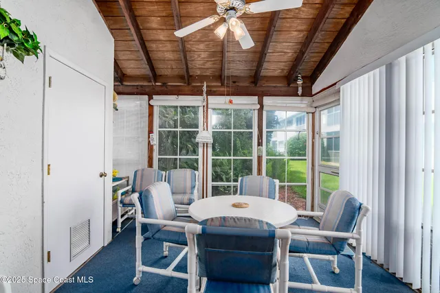 a view of a dining room with furniture window and outside view