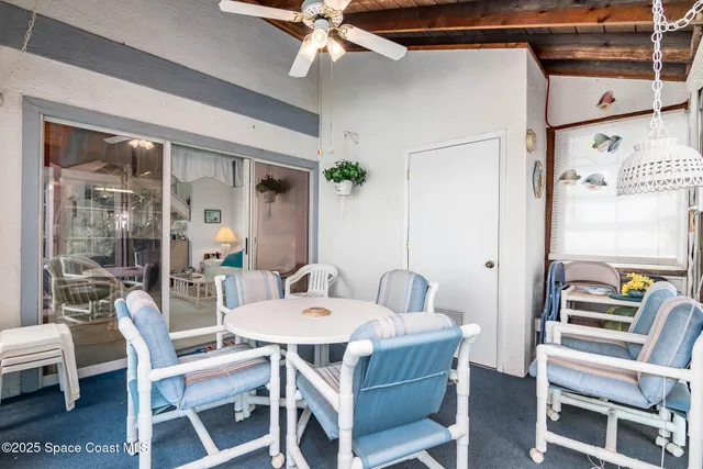 a dining room with furniture and window