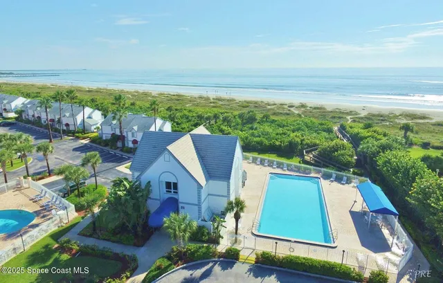 an aerial view of house with yard swimming pool and outdoor seating