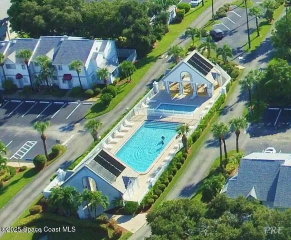 an aerial view of a house with a yard and potted plants