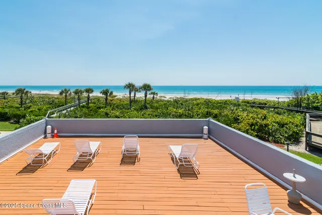 a view of balcony with wooden floor and seating space