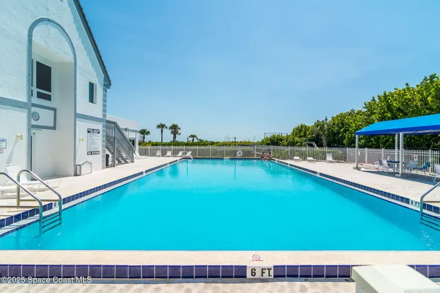 a view of a swimming pool with a lounge chair