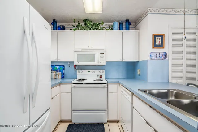 a kitchen with a sink a stove and cabinets