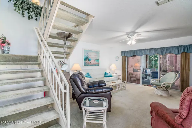 a view of a livingroom with furniture and a ceiling fan