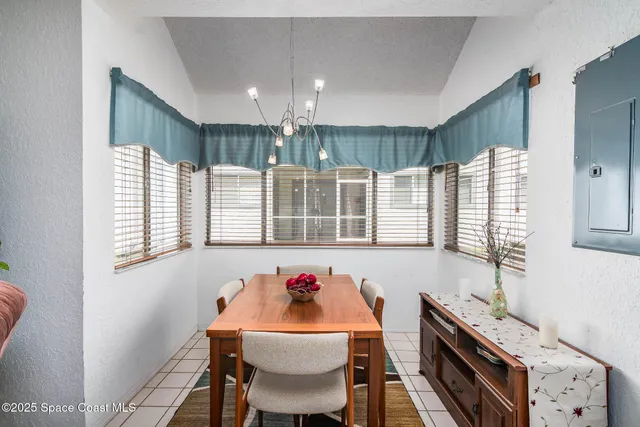 a dining room with furniture and a large window
