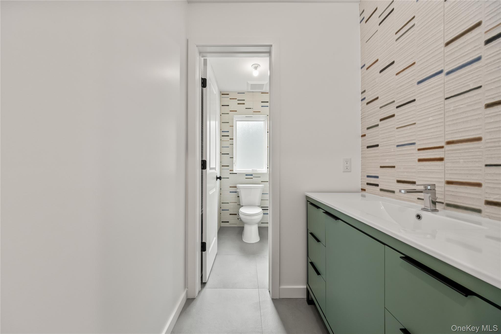 23 Singer Avenue, Unit 211 Spring Valley, NY 10977 - Photo 31 of 45 a bathroom with a sink a toilet and shower