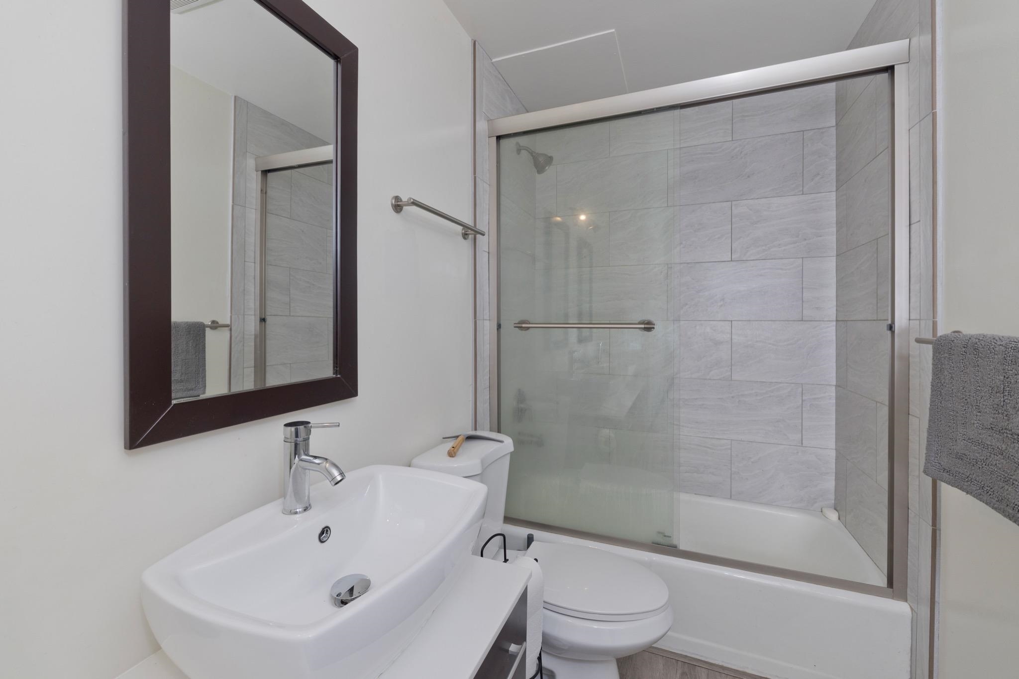 165 Old Mammoth Road, Unit 13 Mammoth Lakes, CA 93546 - Photo 15 of 23 Bathroom featuring a contemporary vessel sink, chrome faucet, and a framed wall mirror