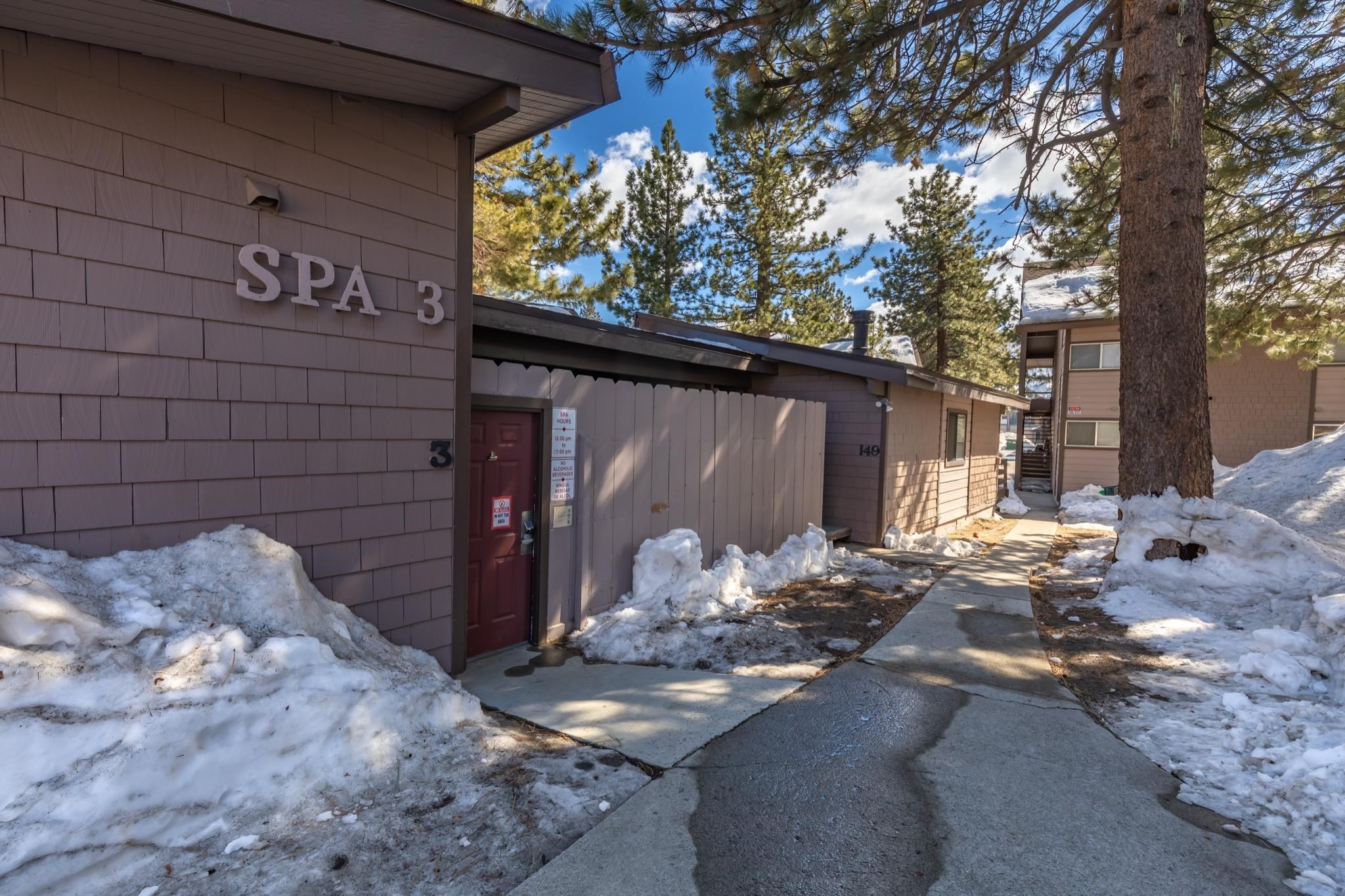 165 Old Mammoth Road, Unit 13 Mammoth Lakes, CA 93546 - Photo 22 of 23 Cedar shake siding exterior with a red entry door