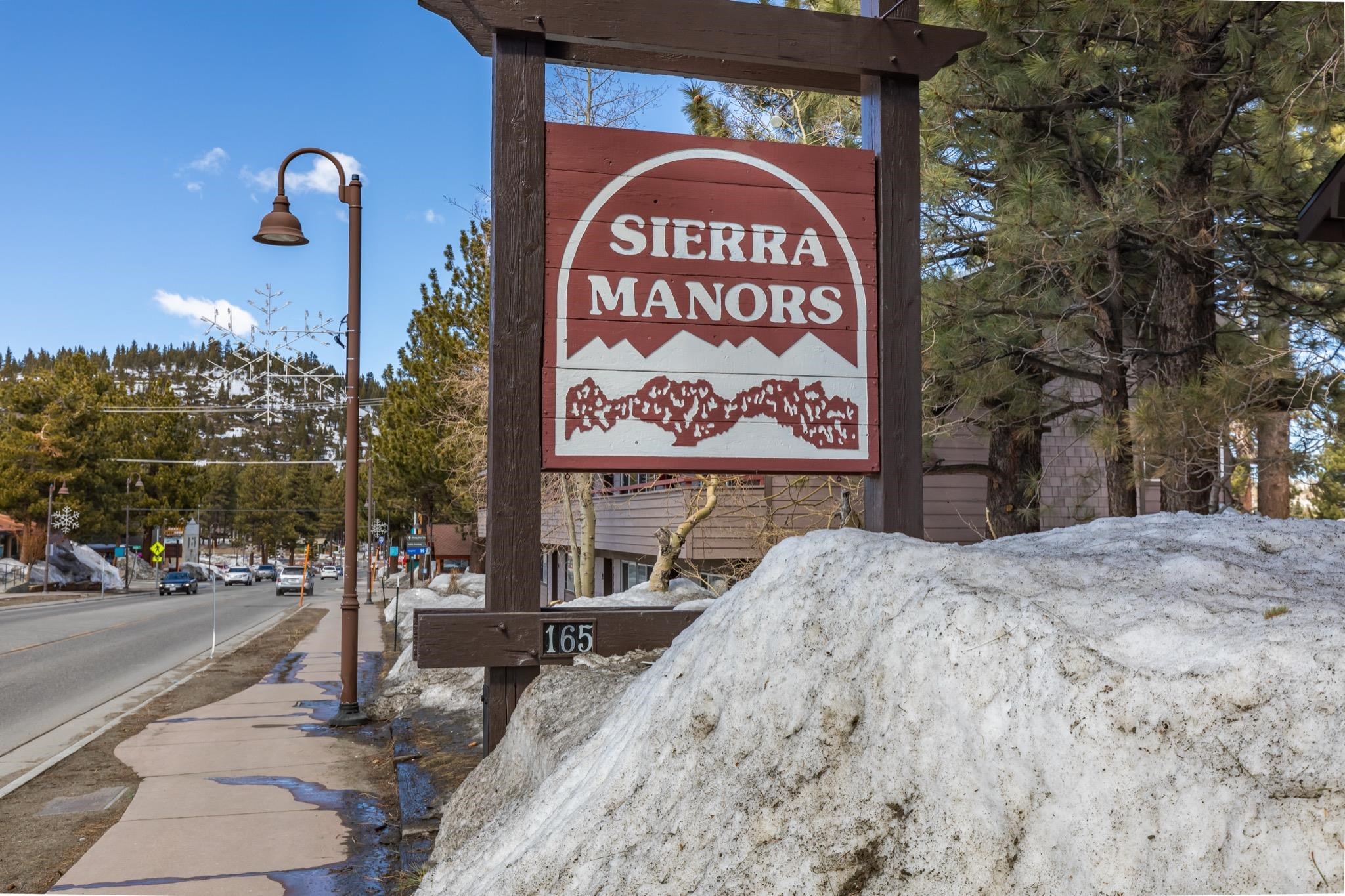 165 Old Mammoth Road, Unit 13 Mammoth Lakes, CA 93546 - Photo 23 of 23 Sierra Manors signage featuring a rustic wood frame and mountain graphic