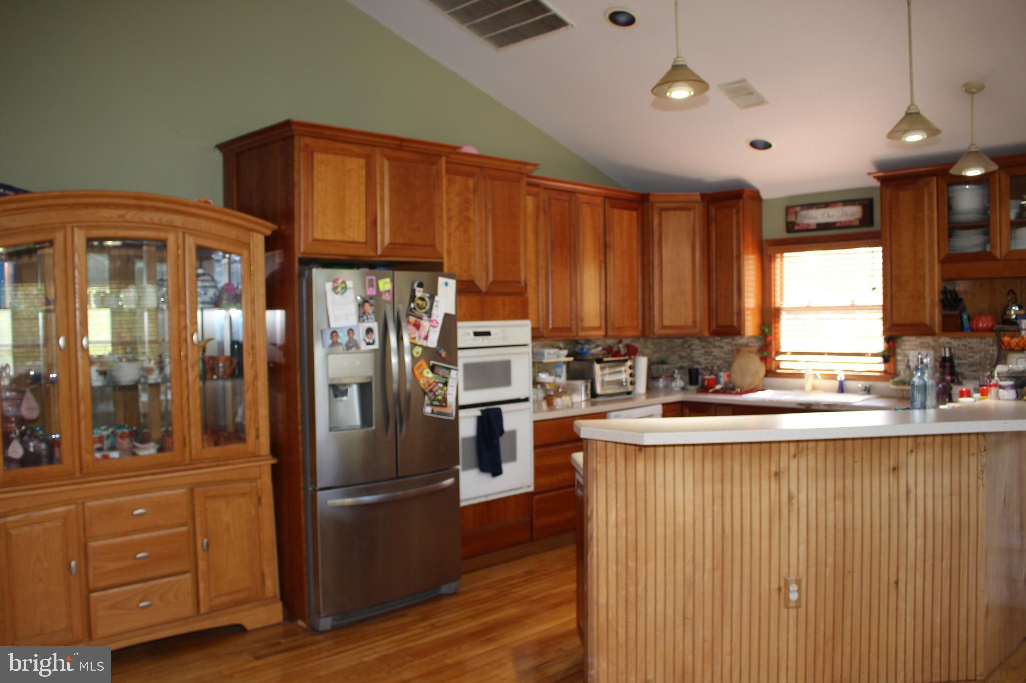 80 Chews Landing Road Clementon, NJ 08021 - Photo 36 of 50 a kitchen with stainless steel appliances granite countertop a refrigerator a sink dishwasher and wooden cabinets with wooden floor