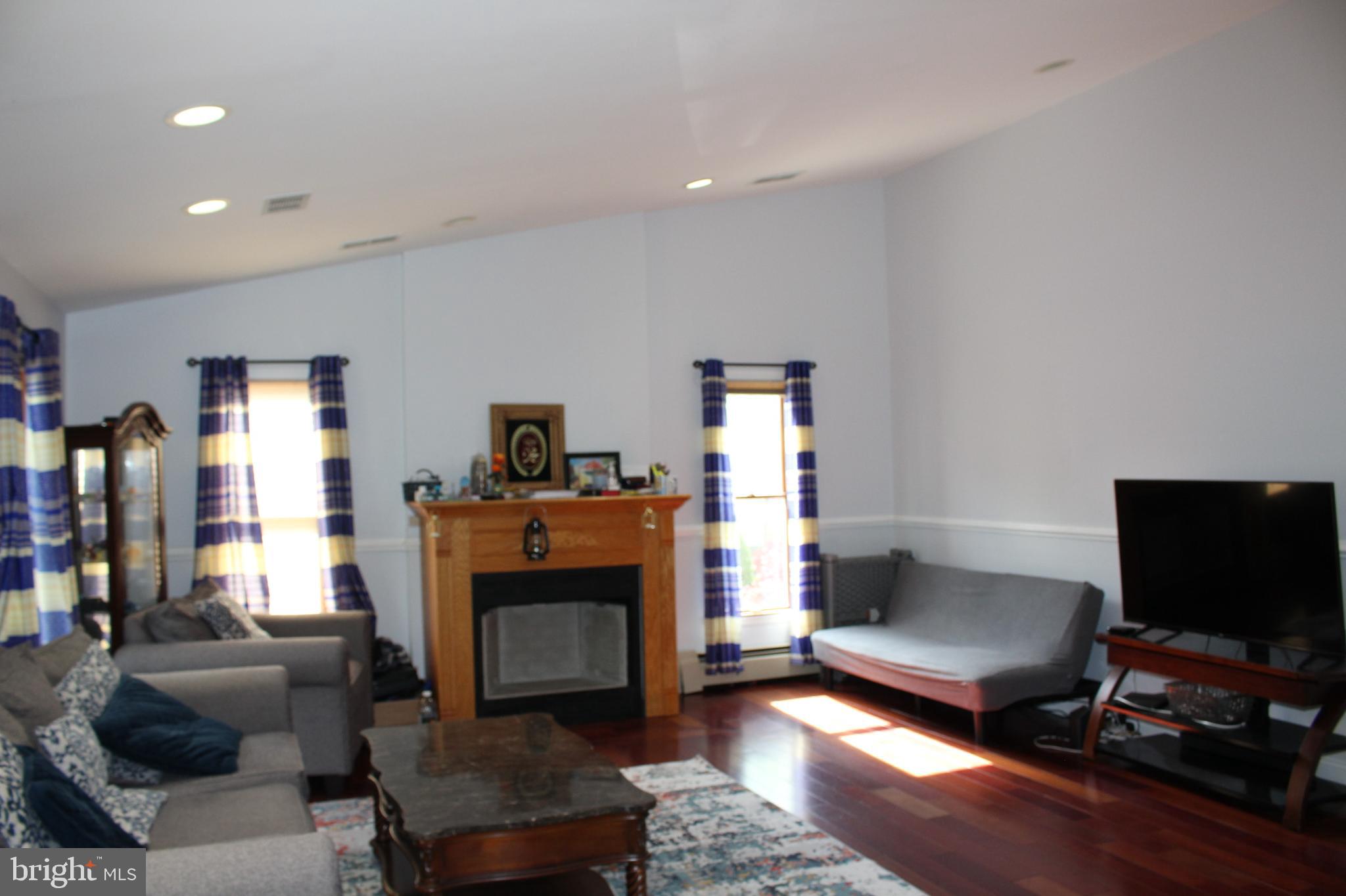 80 Chews Landing Road Clementon, NJ 08021 - Photo 43 of 50 a living room with furniture a flat screen tv and a fireplace
