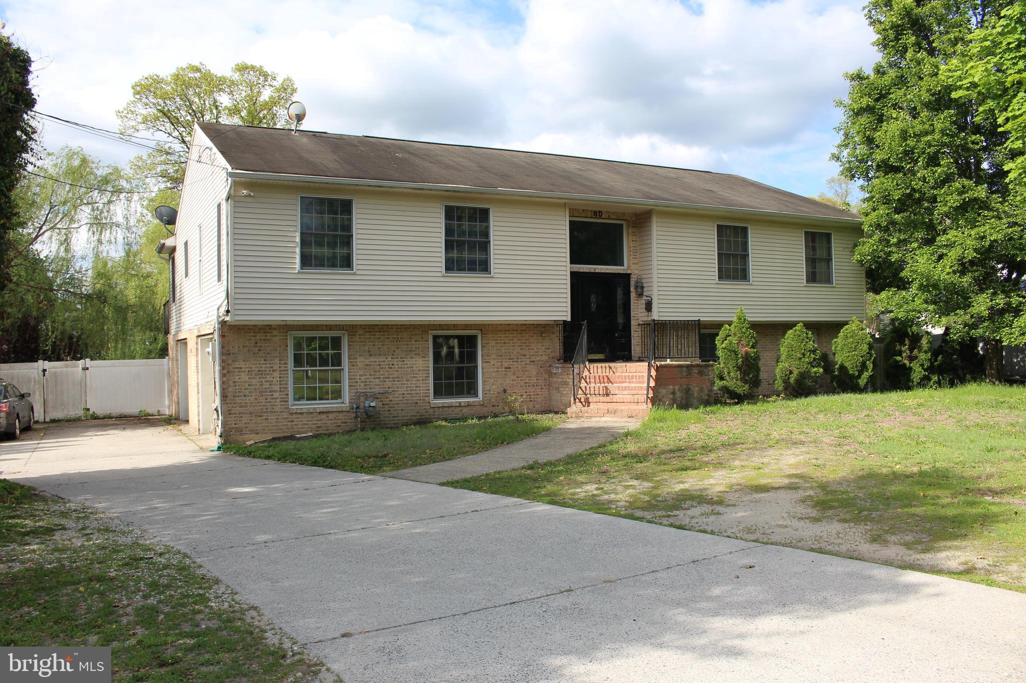 80 Chews Landing Road Clementon, NJ 08021 - Photo 8 of 50 a front view of a house with a yard and garage