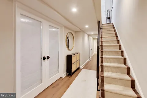 a view of a hallway with entryway wooden floor and front door