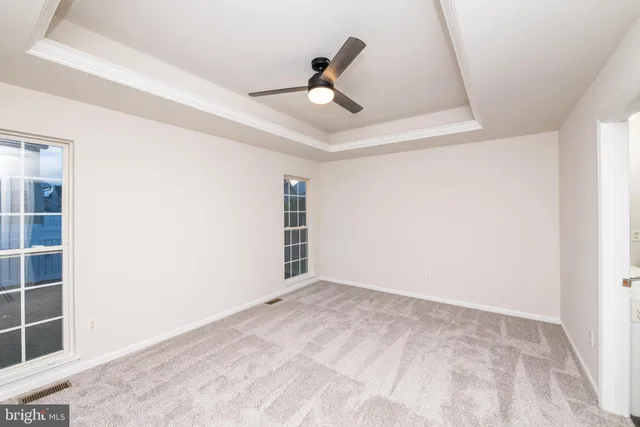 a view of empty room with ceiling fan