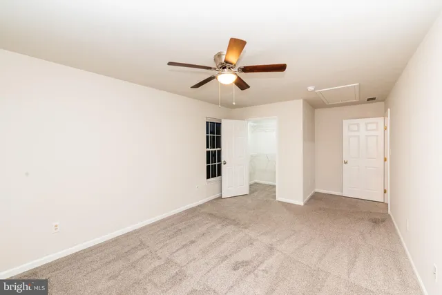 a view of a big room with wooden floor and windows in a room