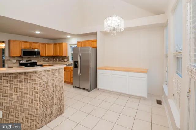 a view of a kitchen with furniture and an empty room