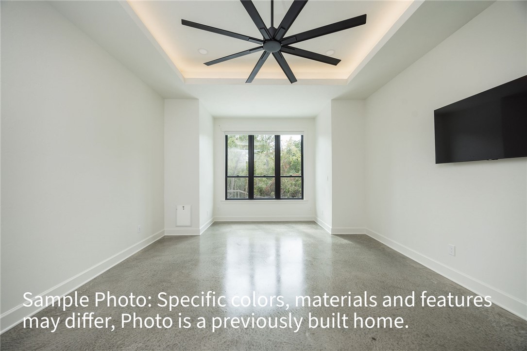 7048 Skipping Rock Path Bryan, TX 77808 - Photo 7 of 16 an empty room with windows and ceiling fan