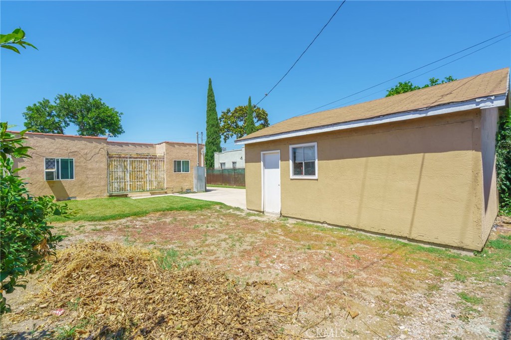 346 West School Street Compton, CA 90220 - Photo 26 of 29 a view of a house with backyard and a tree