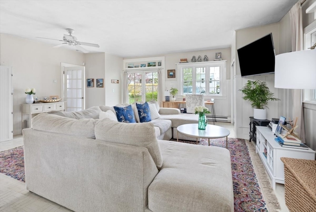 4 C Street Hull, MA 02045 - Photo 6 of 17 a living room with furniture a flat screen tv and a large window