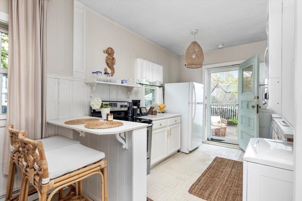 4 C Street Hull, MA 02045 - Photo 10 of 17 a kitchen that has a lot of white cabinets and stainless steel appliances