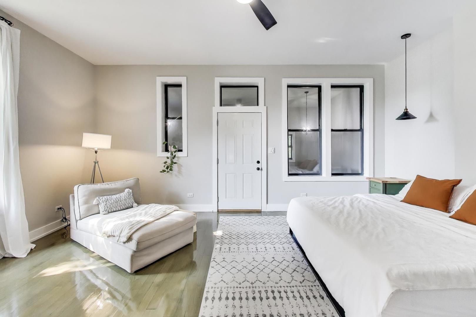 2742 West Polk Street Chicago, IL 60612 - Photo 18 of 50 a bedroom with a bed lamps and a dresser