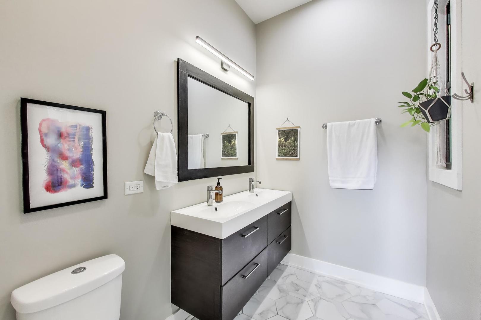 2742 West Polk Street Chicago, IL 60612 - Photo 20 of 50 a bathroom with a toilet sink and mirror