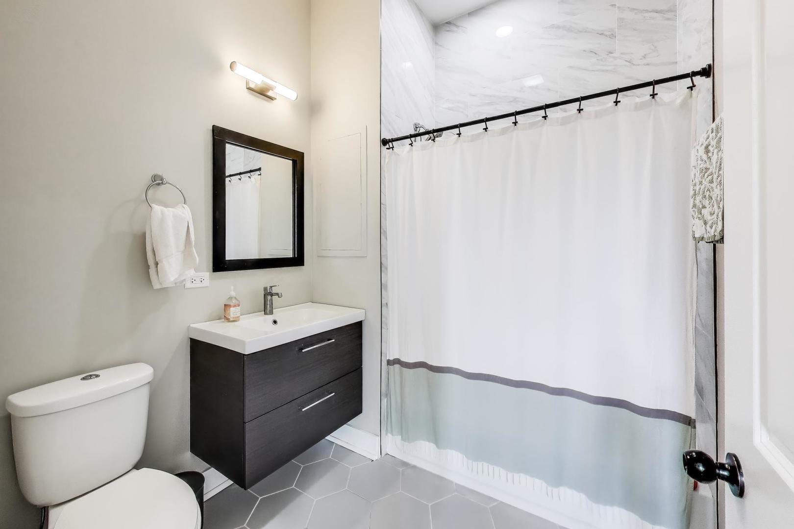 2742 West Polk Street Chicago, IL 60612 - Photo 25 of 50 a bathroom with a toilet sink and mirror