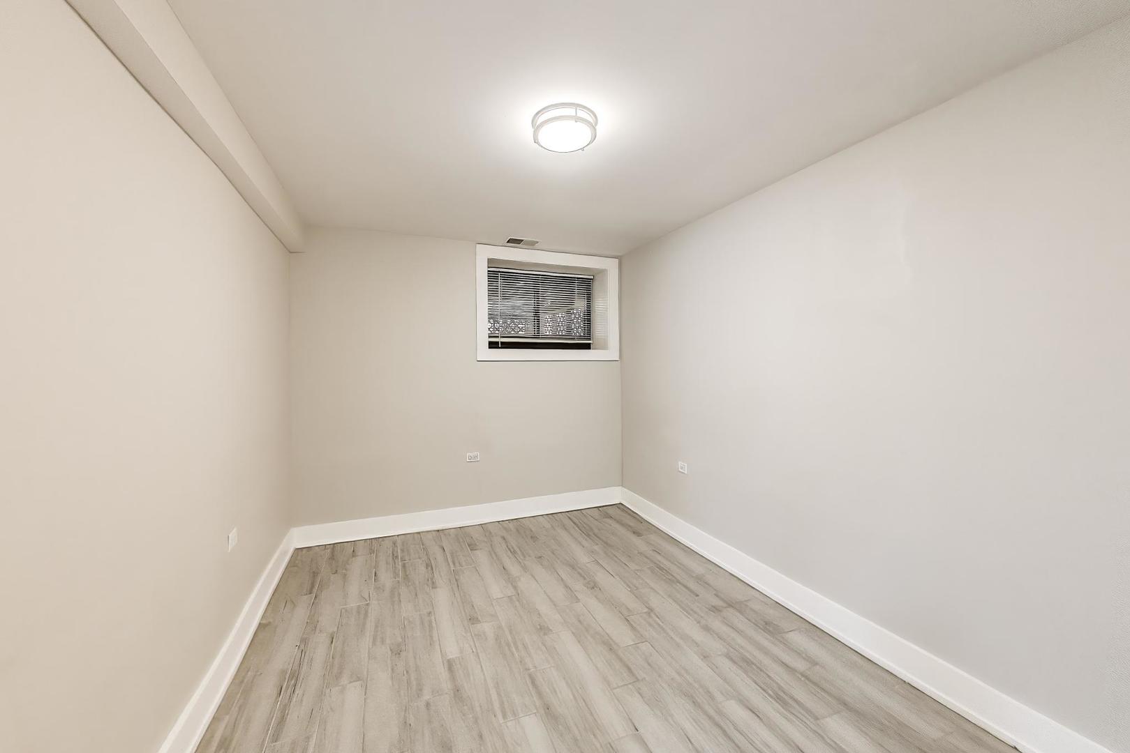 2742 West Polk Street Chicago, IL 60612 - Photo 33 of 50 a view of room with wooden floor and fan