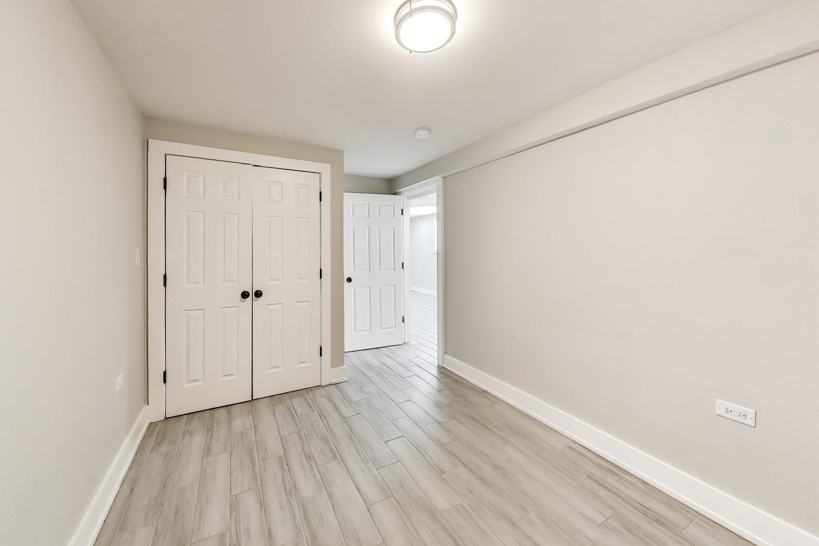 2742 West Polk Street Chicago, IL 60612 - Photo 34 of 50 a view of an empty room with wooden floor