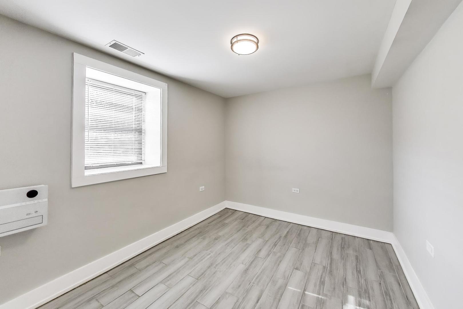 2742 West Polk Street Chicago, IL 60612 - Photo 36 of 50 a view of a room that has wooden floor and windows in it