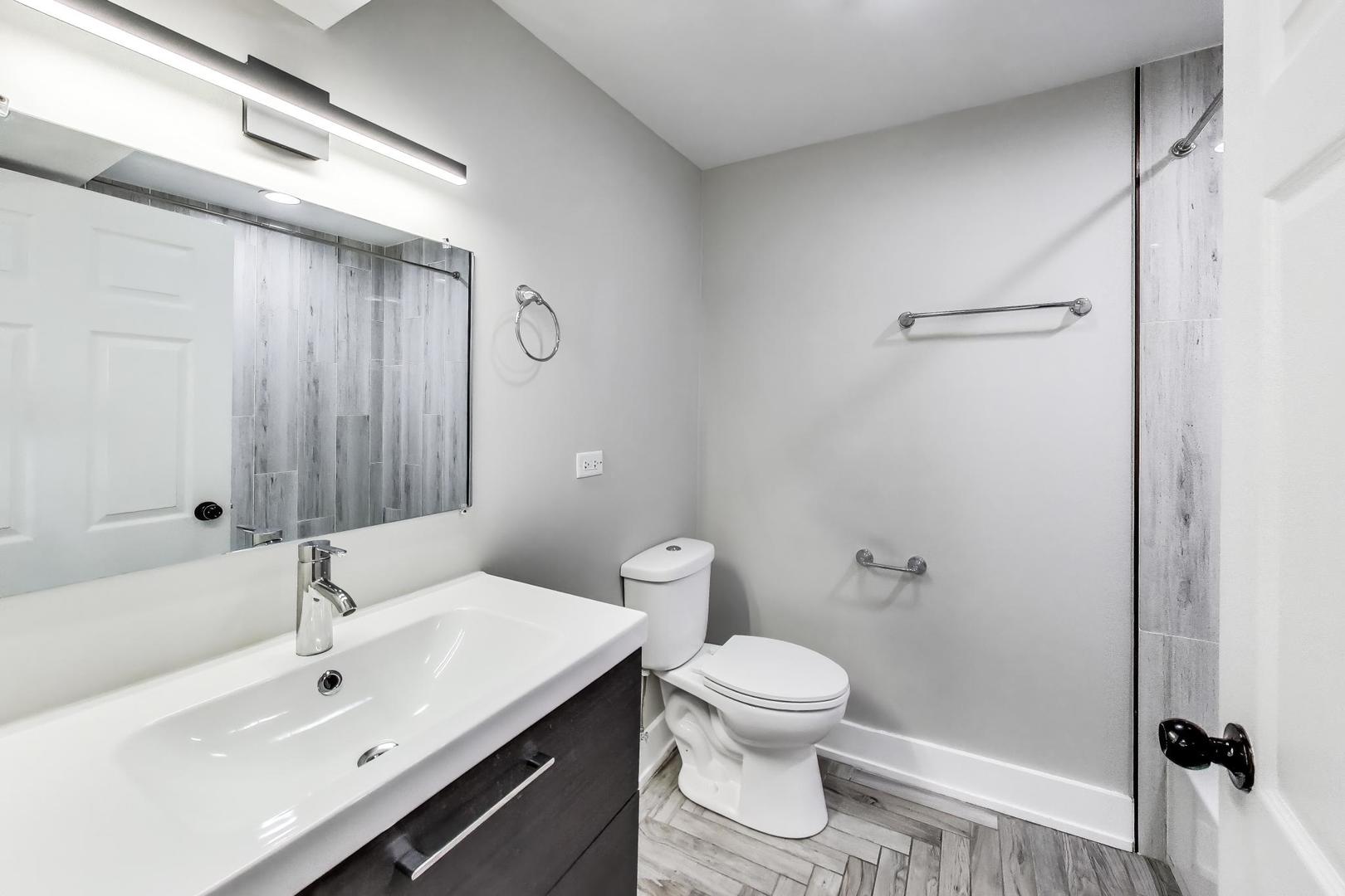 2742 West Polk Street Chicago, IL 60612 - Photo 39 of 50 a bathroom with a sink toilet and shower