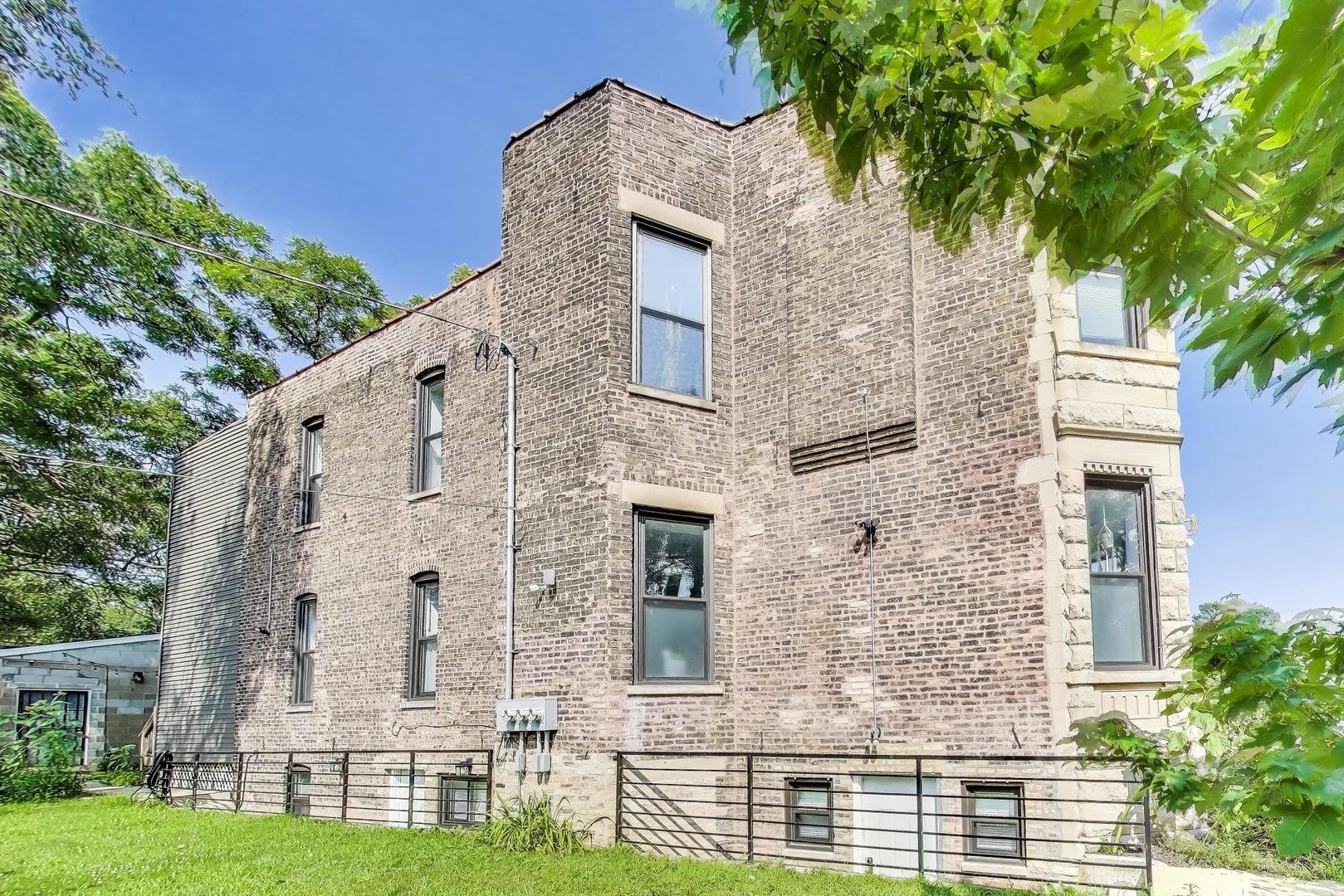 2742 West Polk Street Chicago, IL 60612 - Photo 43 of 50 front view of a brick house with a yard