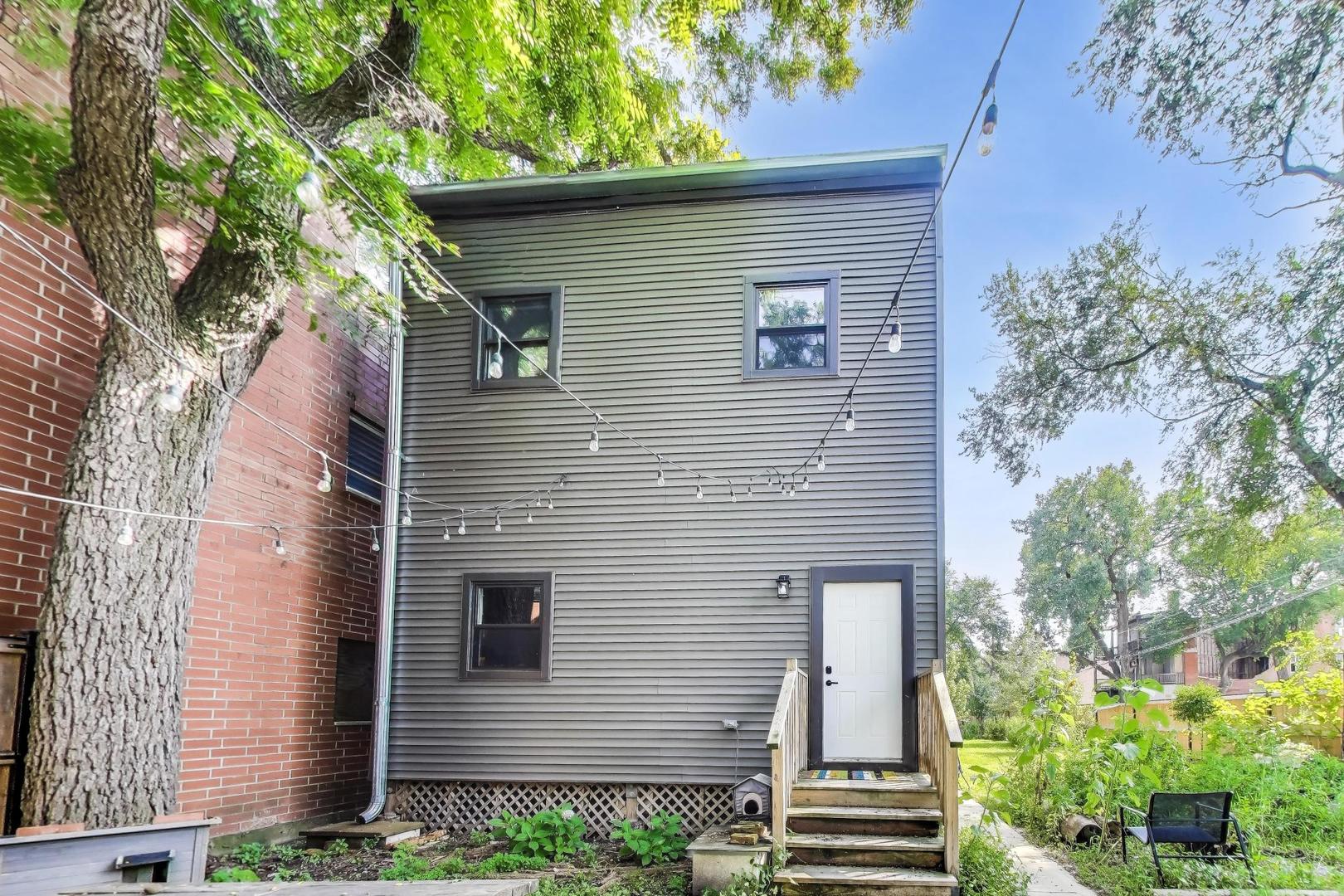 2742 West Polk Street Chicago, IL 60612 - Photo 47 of 50 a view of a house with a yard and plants