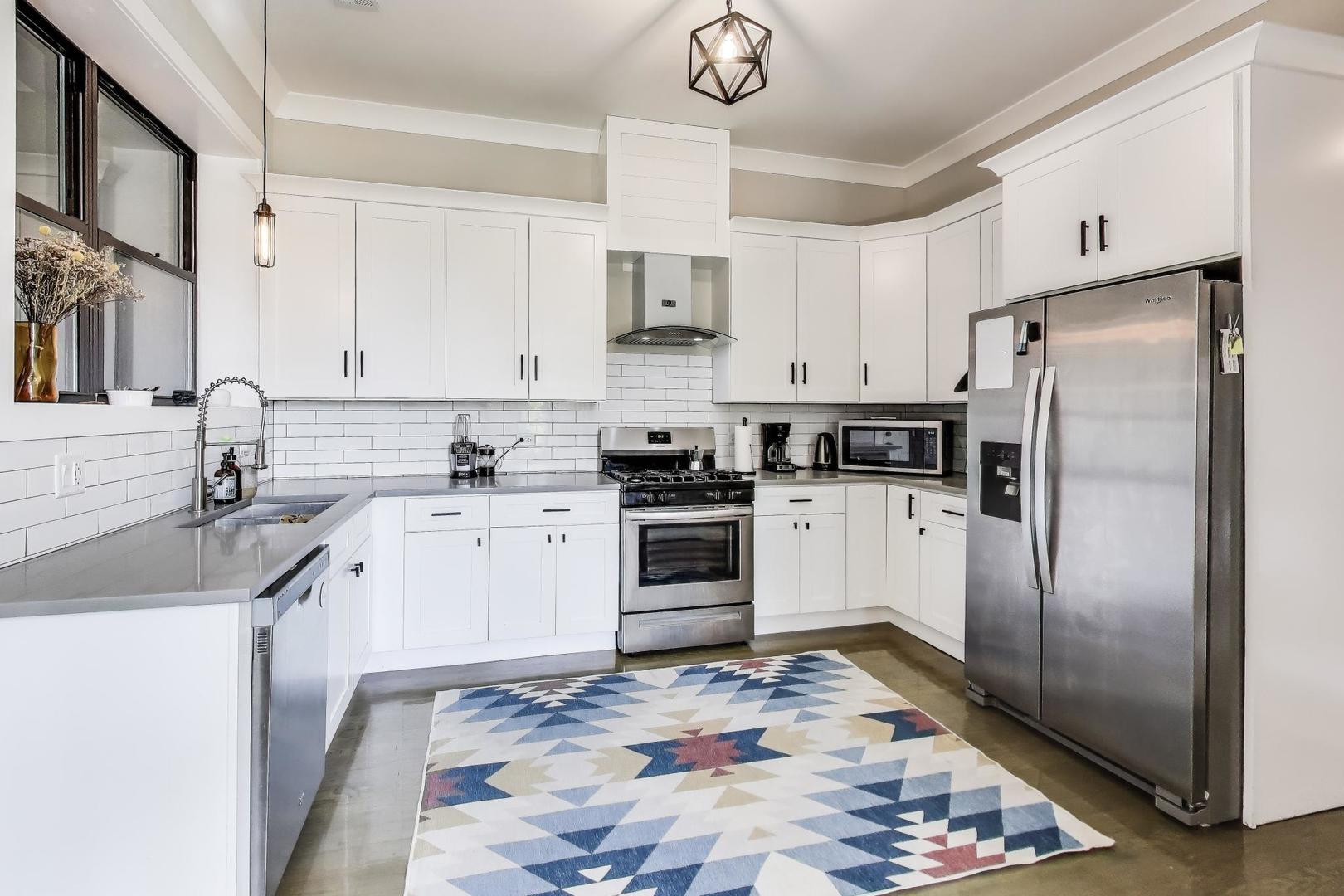 2742 West Polk Street Chicago, IL 60612 - Photo 5 of 50 a kitchen with stainless steel appliances granite countertop a refrigerator sink and stove