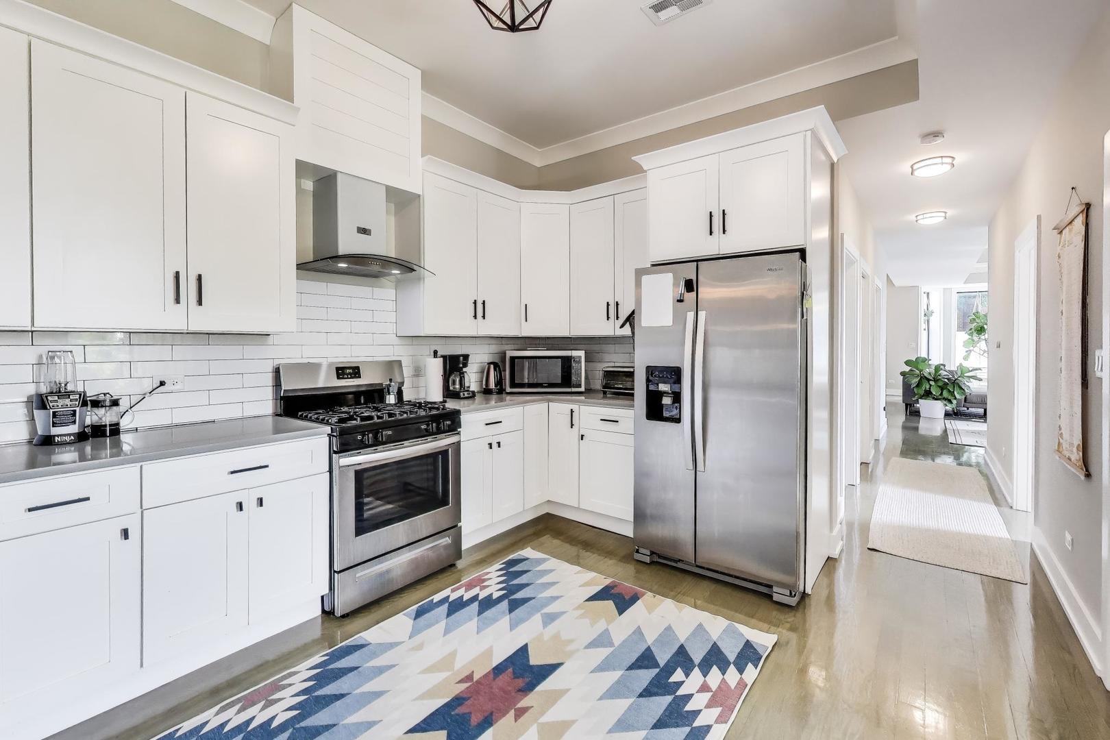 2742 West Polk Street Chicago, IL 60612 - Photo 7 of 50 a kitchen with stainless steel appliances a refrigerator sink and microwave